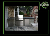 Outdoor kitchen, granite counter top on a flagstone and decorative concrete patio.